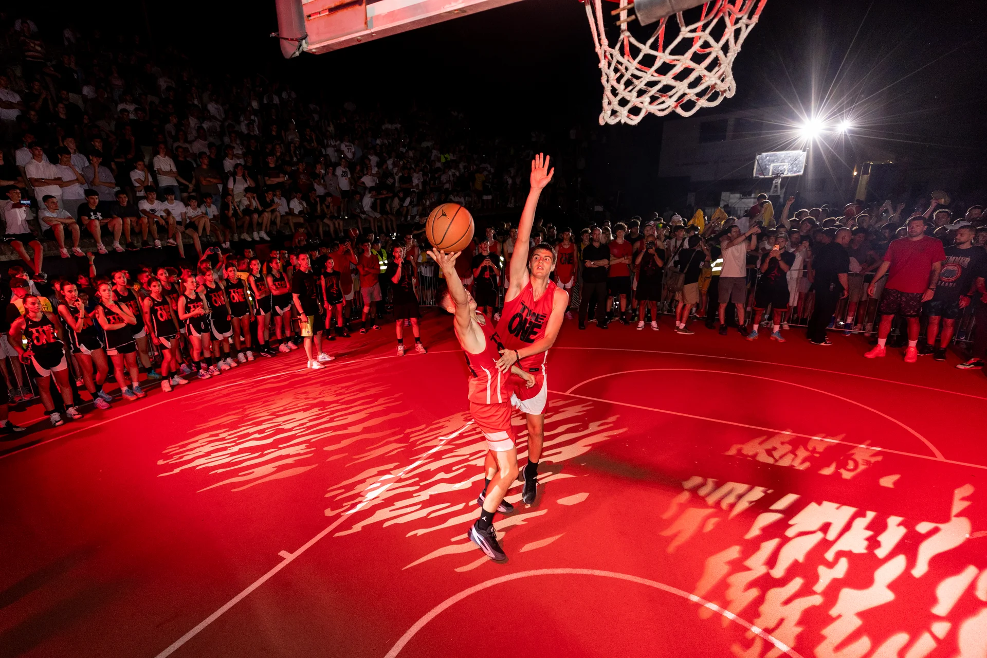 One-on-one basketball action beneath the hoop at Jordan The One in Belgrade